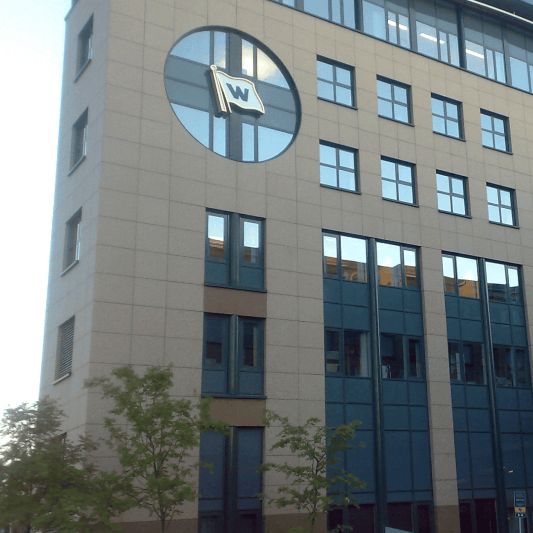 The corporate headquarters building displaying the Wilhelmsen logo, representing the 2015 acquisition of TIMM synthetic rope factory.