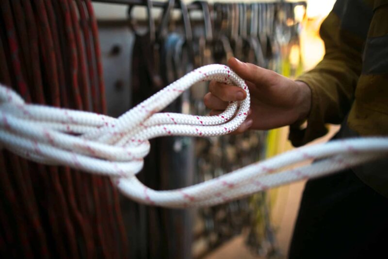 Quality inspection of a synthetic rope loop splice by an industrial specialist.