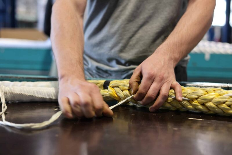 Hands-on industrial safety training session for synthetic rope handling and splicing techniques.